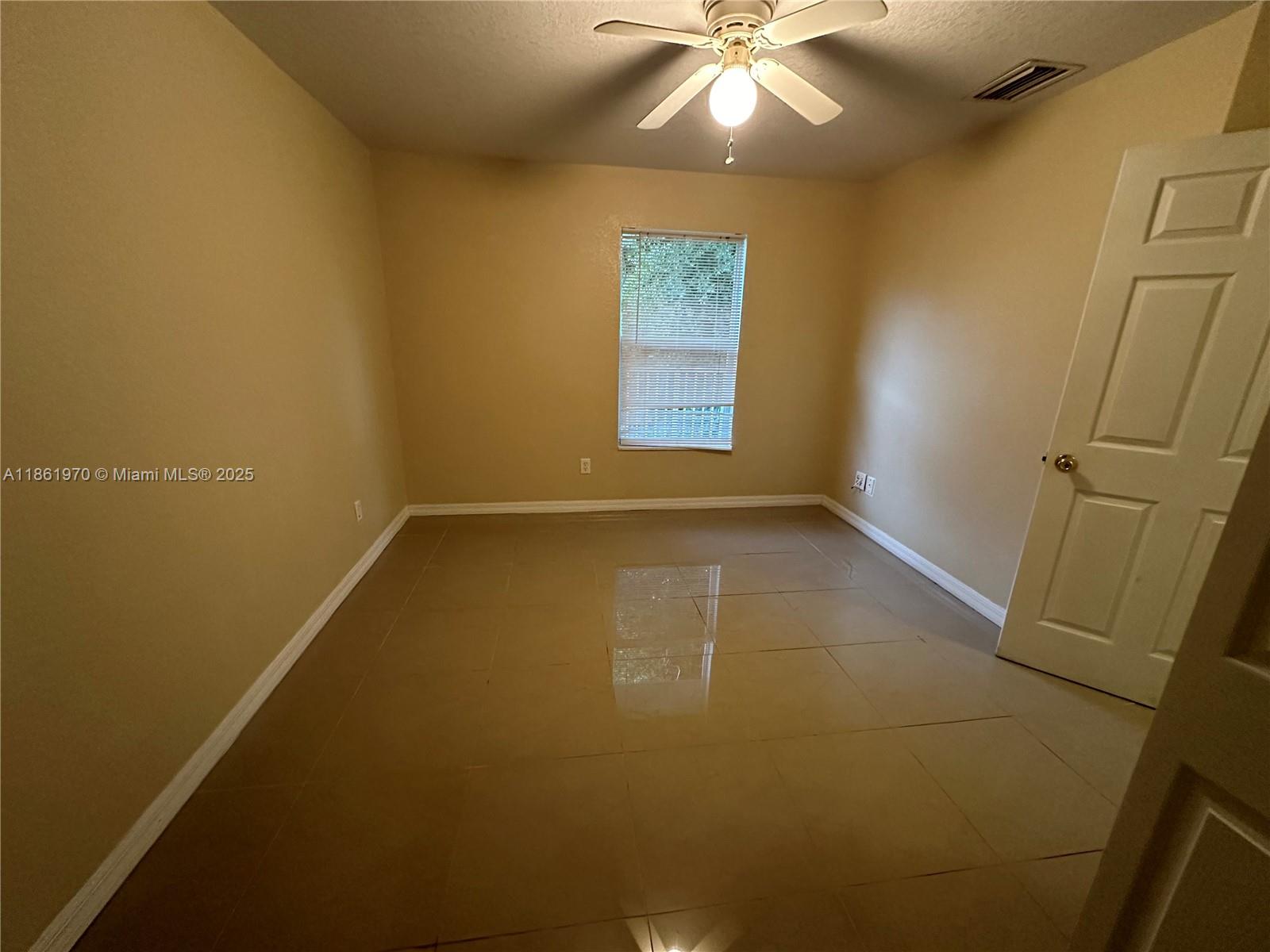 5548 Birdsong Lane, Unit 1 Bokeelia, FL 33922 - Photo 20 of 24 an empty room with a empty space and a window