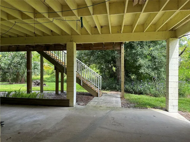 a view of a room with wooden floor and roof