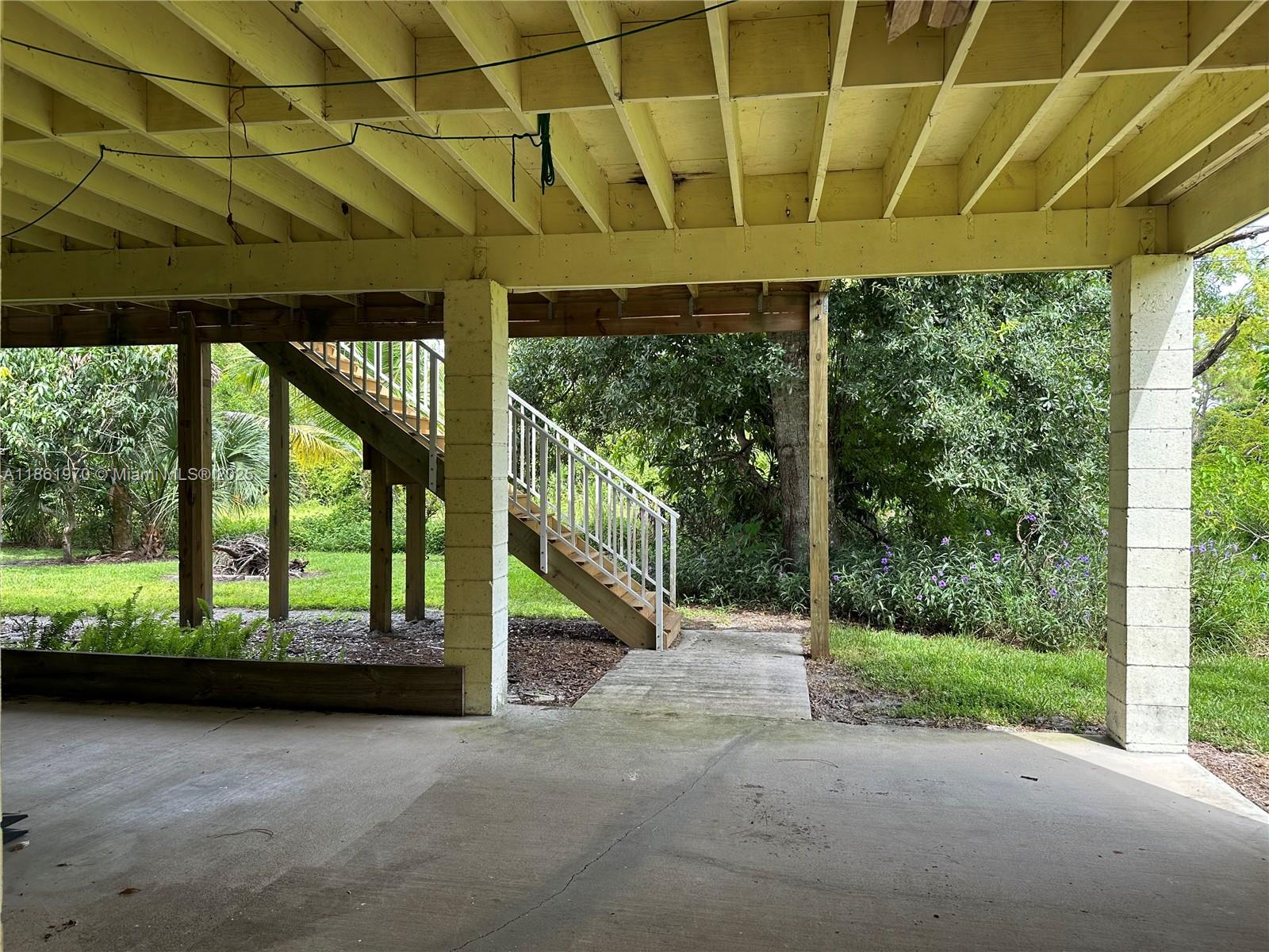 5548 Birdsong Lane, Unit 1 Bokeelia, FL 33922 - Photo 5 of 24 a view of a room with wooden floor and roof