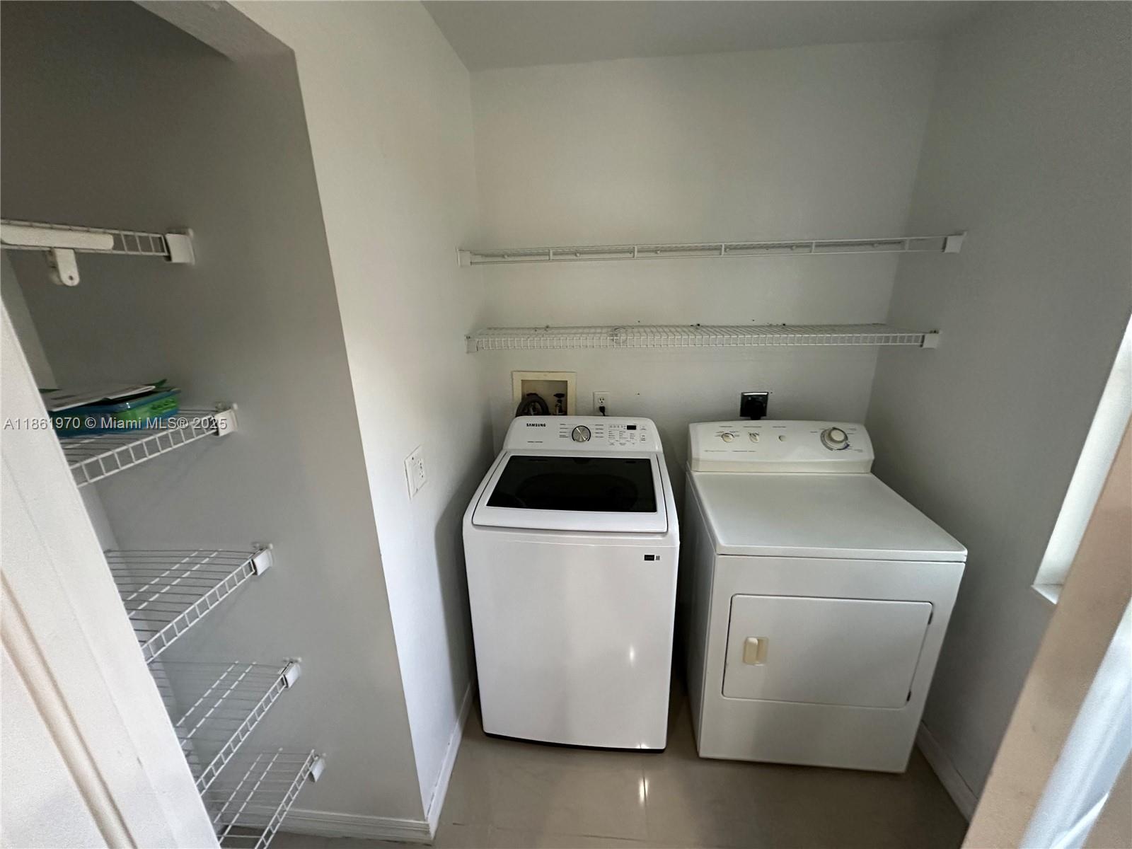 5548 Birdsong Lane, Unit 1 Bokeelia, FL 33922 - Photo 8 of 24 a utility room with dryer and washer