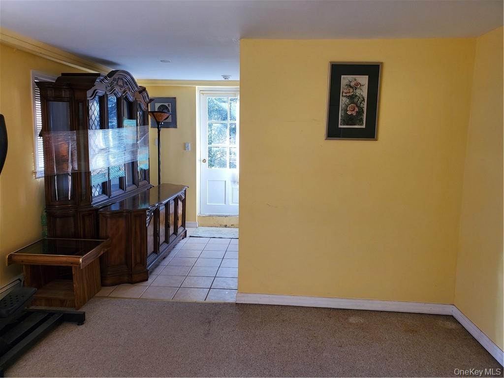 215 Harriman Road Irvington, NY 10533 - Photo 17 of 20 Hallway featuring baseboards, light colored carpet, and light tile patterned floors
