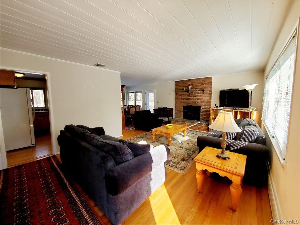 215 Harriman Road Irvington, NY 10533 - Photo 2 of 20 Living room featuring a fireplace, wood finished floors, and visible vents