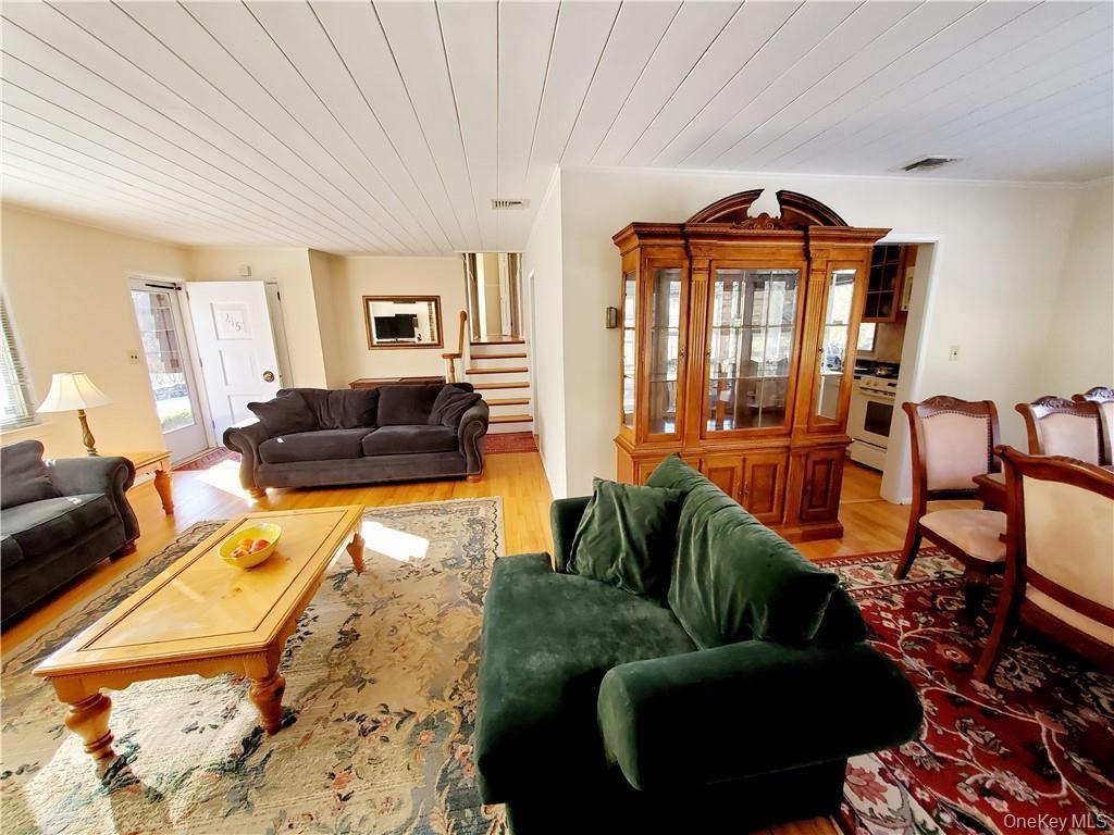 215 Harriman Road Irvington, NY 10533 - Photo 4 of 20 Living room featuring visible vents, stairs, wood finished floors, and wooden ceiling