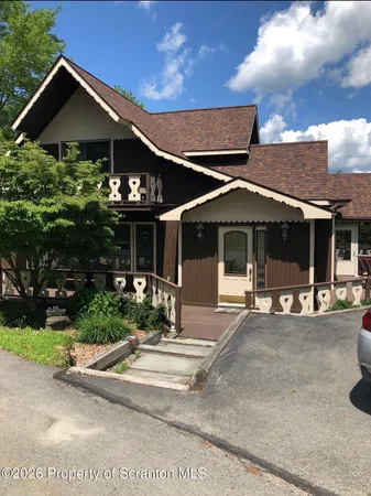 a front view of a house with yard outdoor seating and barbeque oven