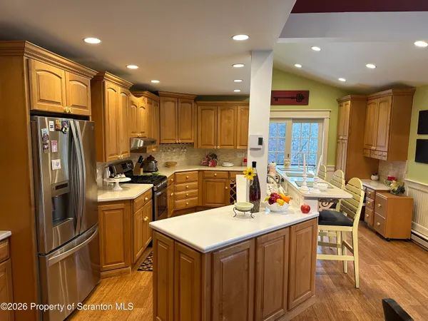a dining room with furniture a chandelier and wooden floor