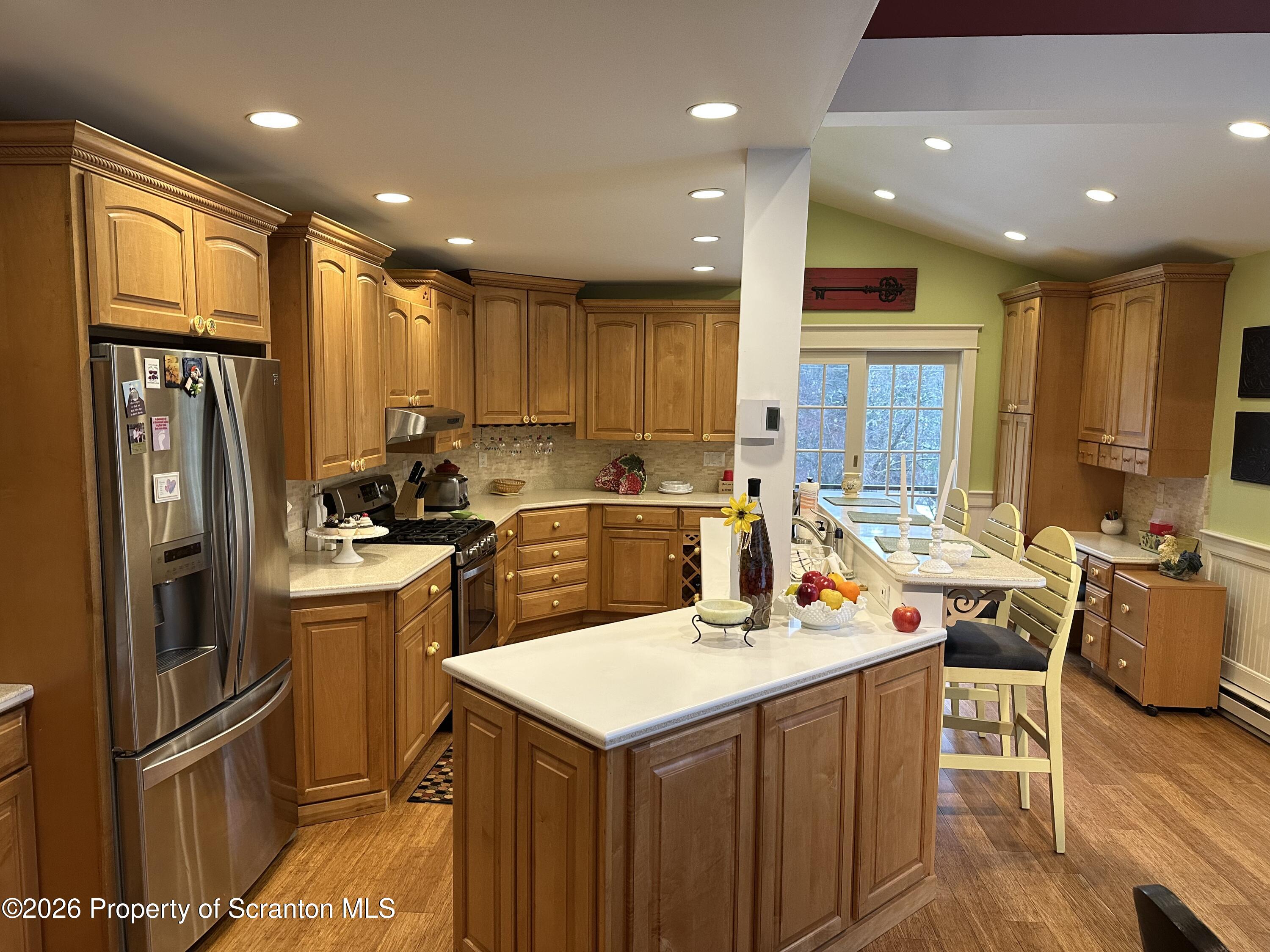 15 Fall Place Union Dale, PA 18470 - Photo 6 of 35 a kitchen with a refrigerator a sink and wooden cabinets
