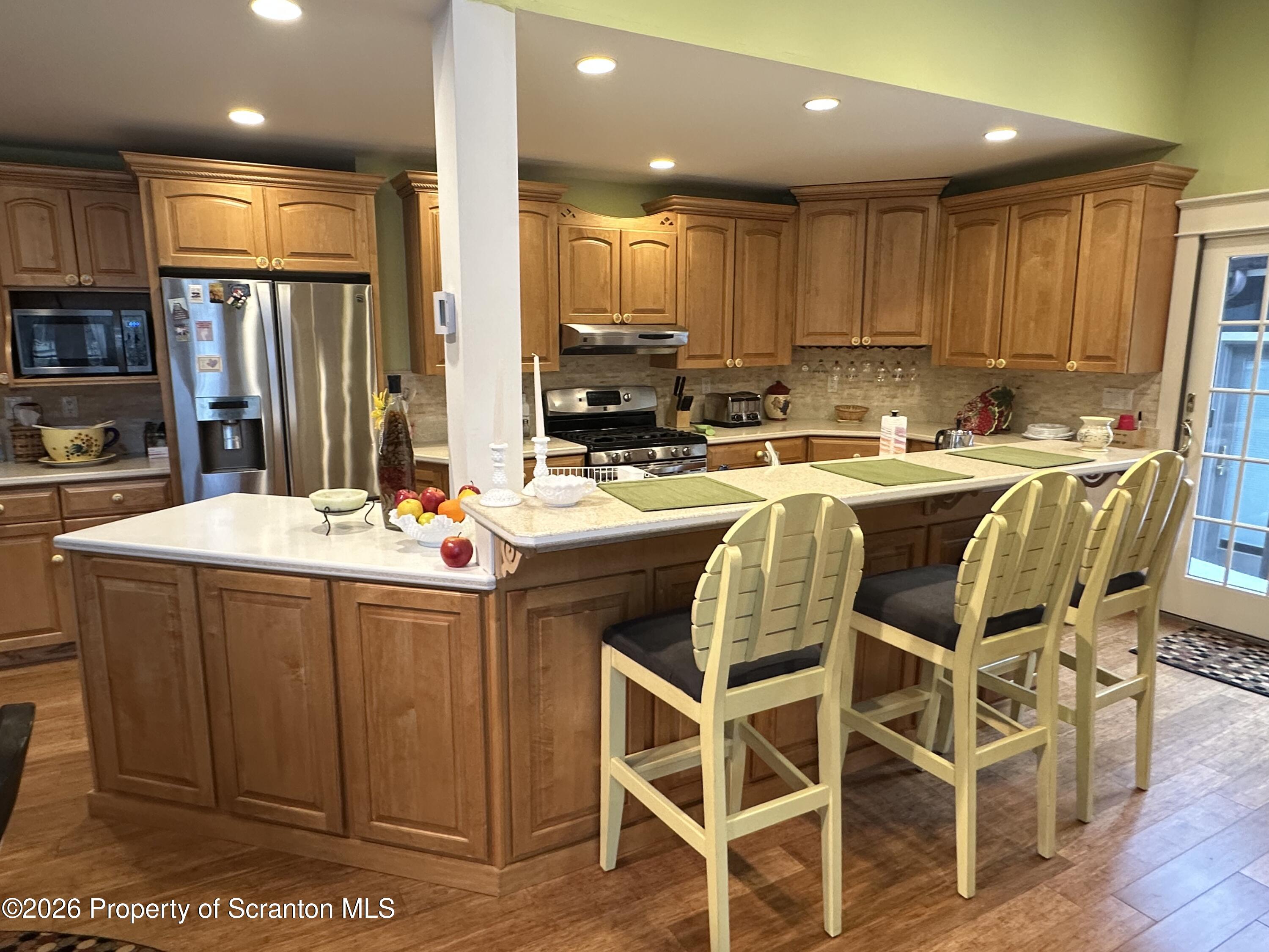 15 Fall Place Union Dale, PA 18470 - Photo 7 of 35 a kitchen with stainless steel appliances kitchen island granite countertop a sink and cabinets