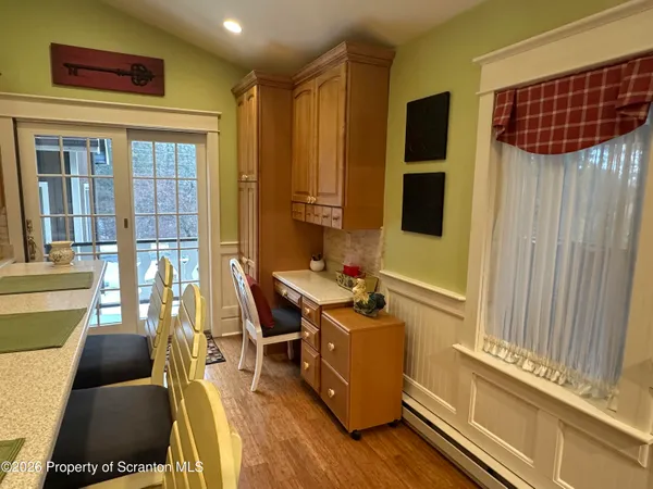 a very nice looking dining room with a large window and chairs