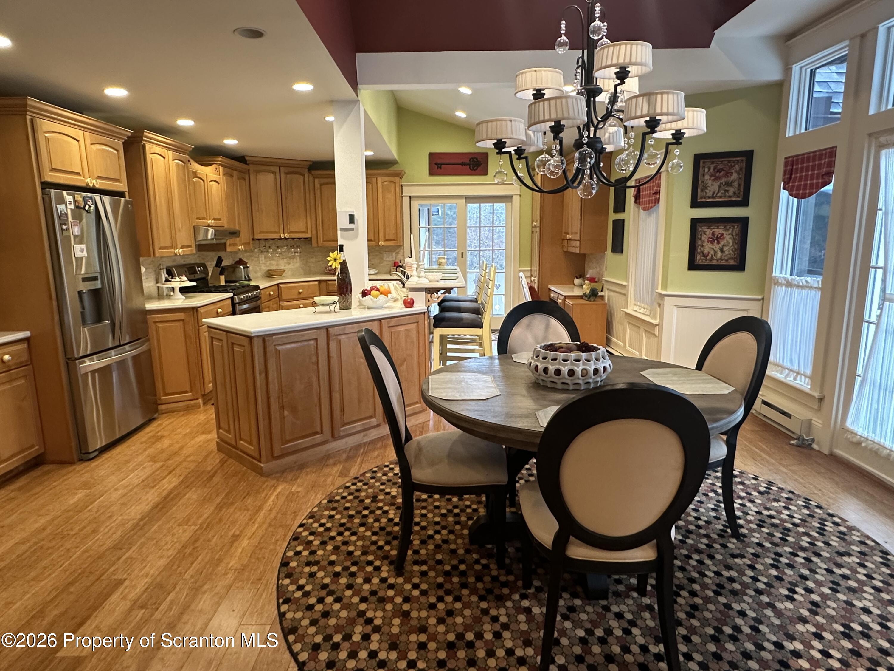 15 Fall Place Union Dale, PA 18470 - Photo 10 of 35 a kitchen with granite countertop a stove a kitchen island a dining table and chairs