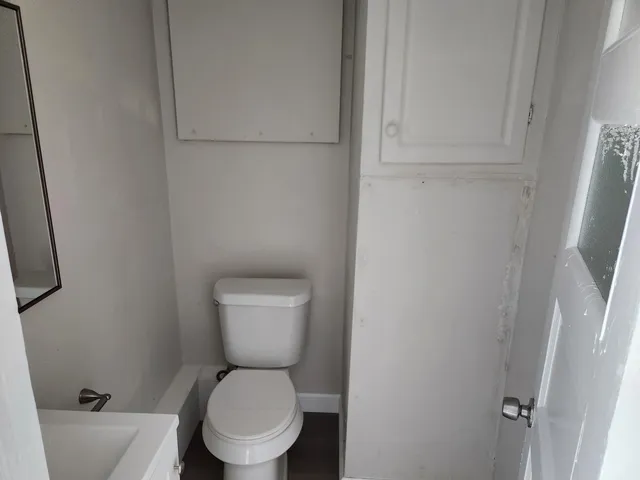 a white toilet sitting next to a toilet