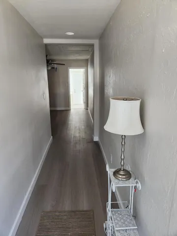 a view of entryway and hall with wooden floor