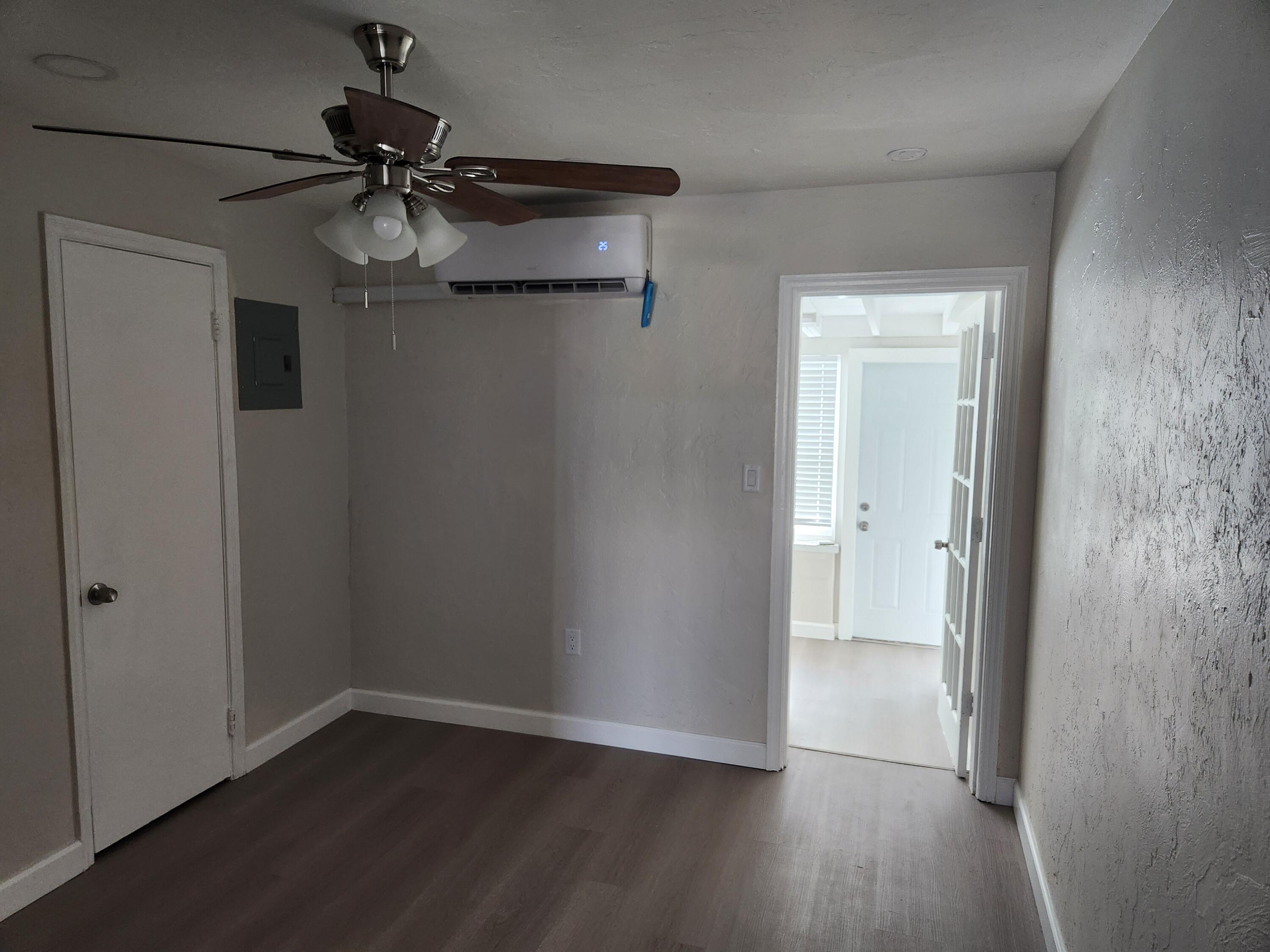 65 West 34th Street, Unit B Riviera Beach, FL 33404 - Photo 5 of 13 wooden floor in an empty room
