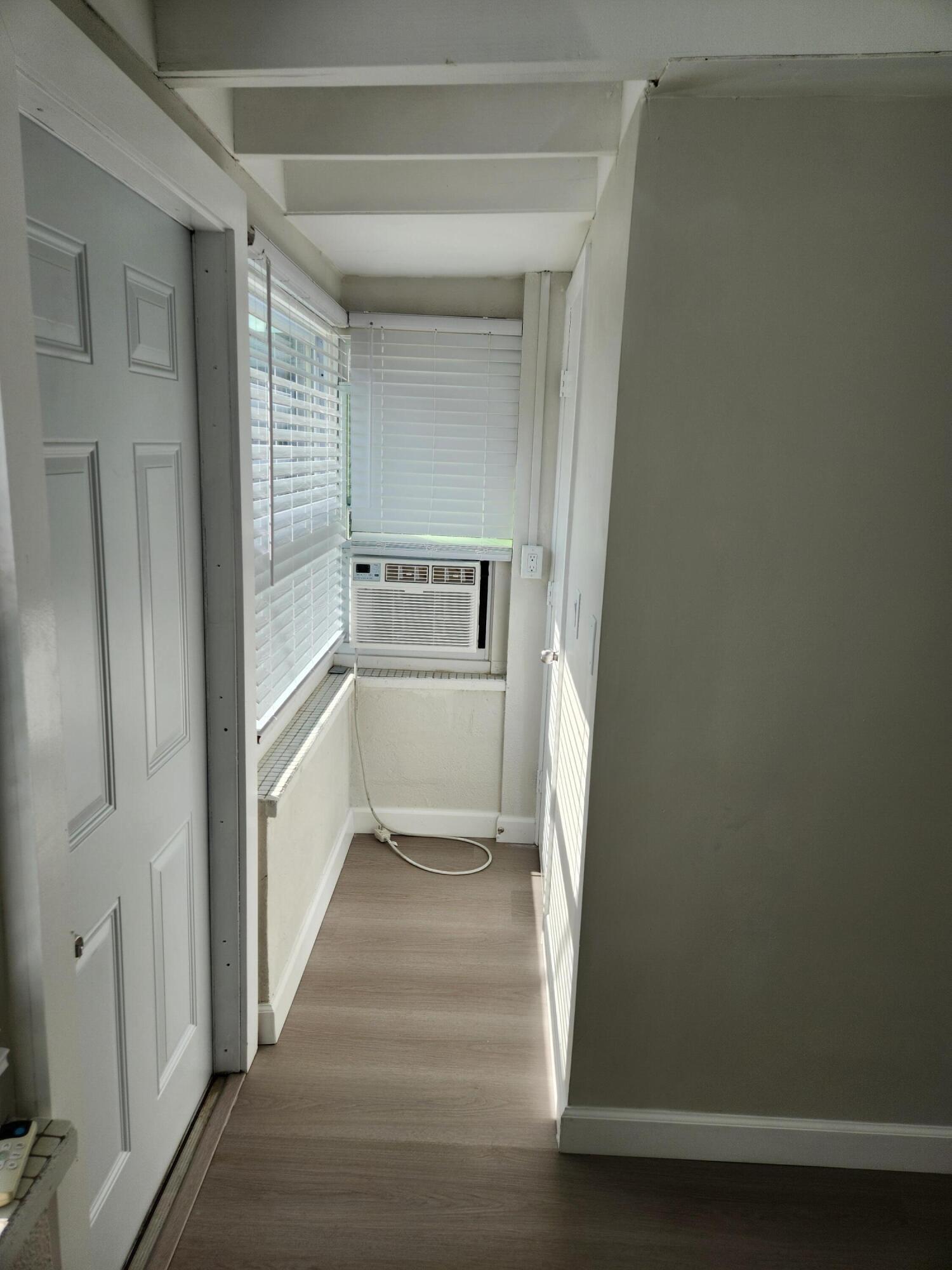 65 West 34th Street, Unit B Riviera Beach, FL 33404 - Photo 9 of 13 a view of a hallway with wooden floor and staircase
