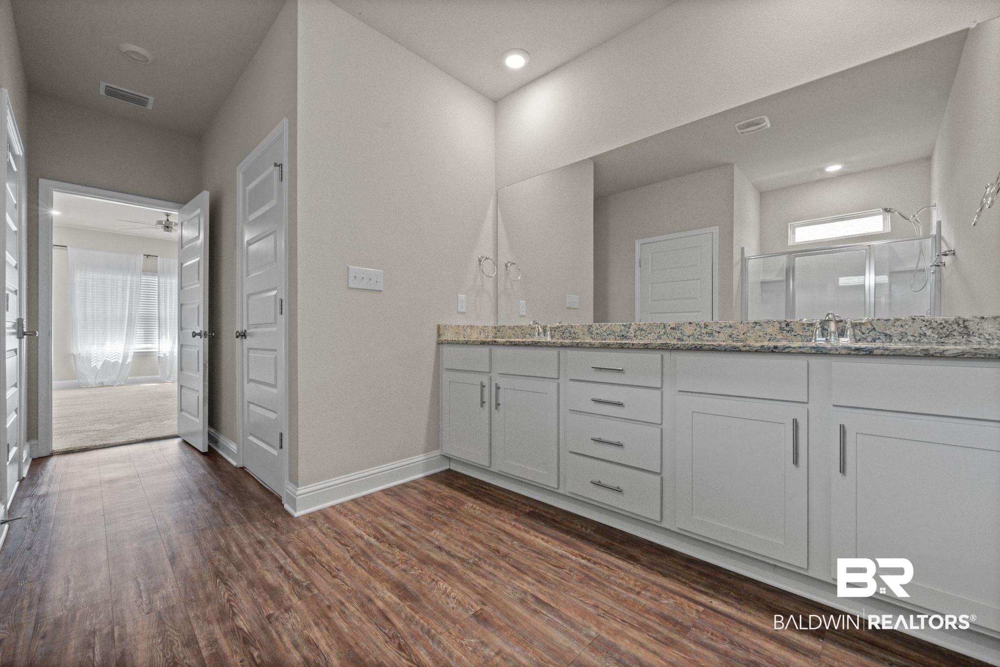 24769 Slater Mill Road Daphne, AL 36526 - Photo 22 of 38 Bathroom featuring ceiling fan, wood-type flooring, and double vanity