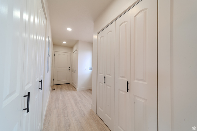 130 Pole Line Road, Unit 2 Roosevelt, UT 84066 - Photo 31 of 33 Hallway entry with light wood-finish flooring, recessed lighting, and multiple white bi-fold doors featuring black hardware