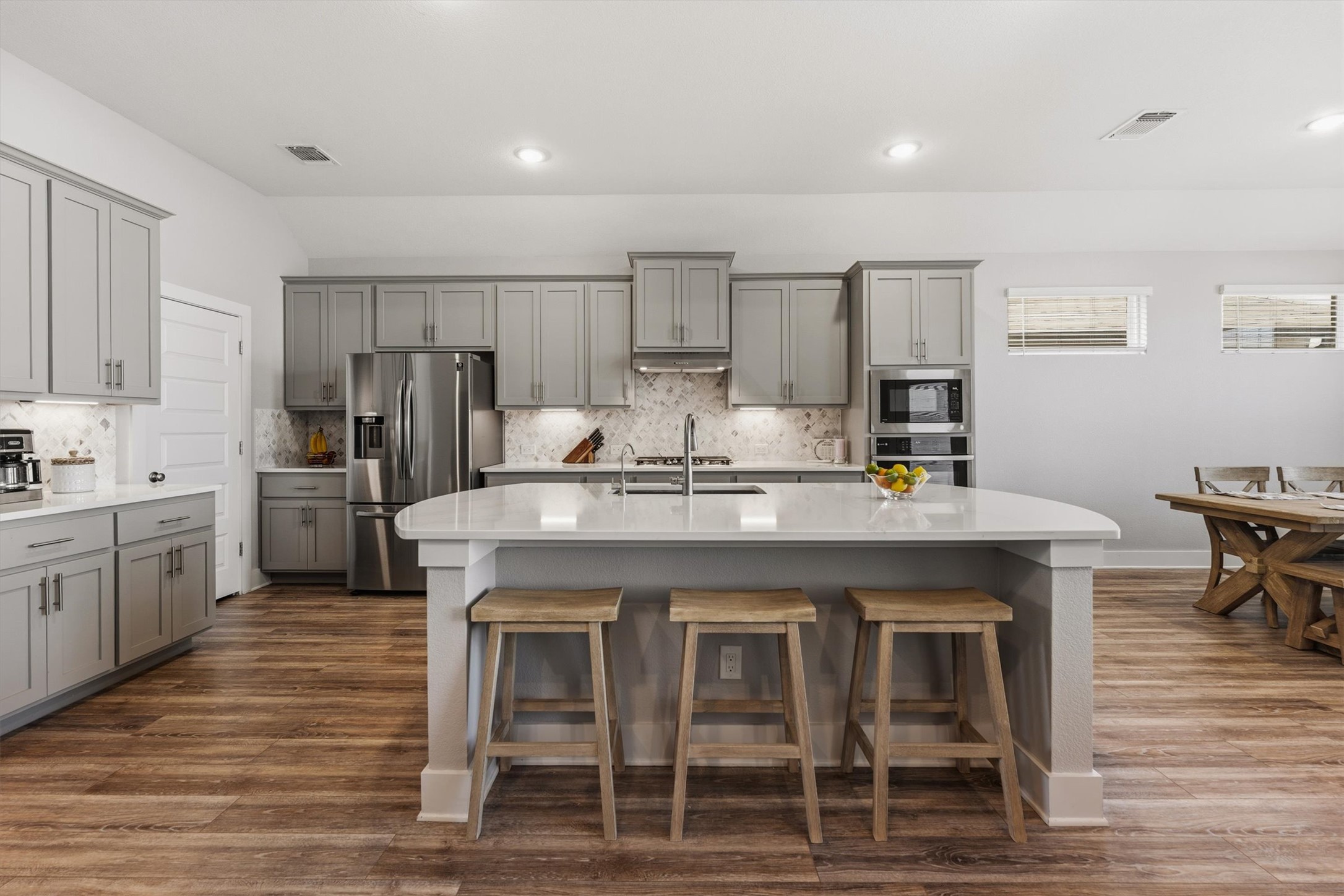 20900 Claire Jean Path Pflugerville, TX 78660 - Photo 7 of 35 a kitchen with kitchen island granite countertop a sink cabinets and stainless steel appliances