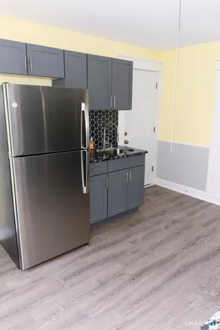 a kitchen with stainless steel appliances a refrigerator and a stove