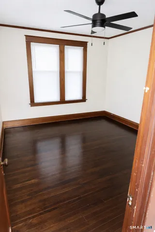 a view of a ceiling fan and a window