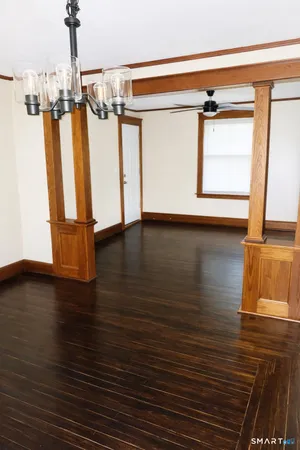 a view of a room with wooden floor and windows