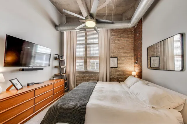 a view of walk in closet with clothes