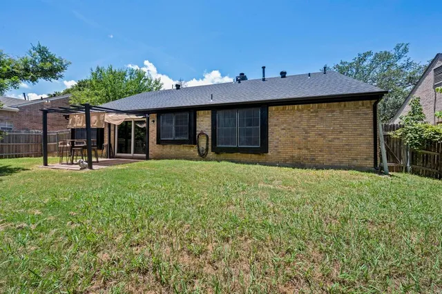 a front view of a house with a yard and potted plants