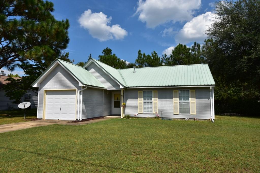 2840 Old Mill Way Crestview, FL 32539 - Photo 1 of 35 a front view of a house with a garden and yard