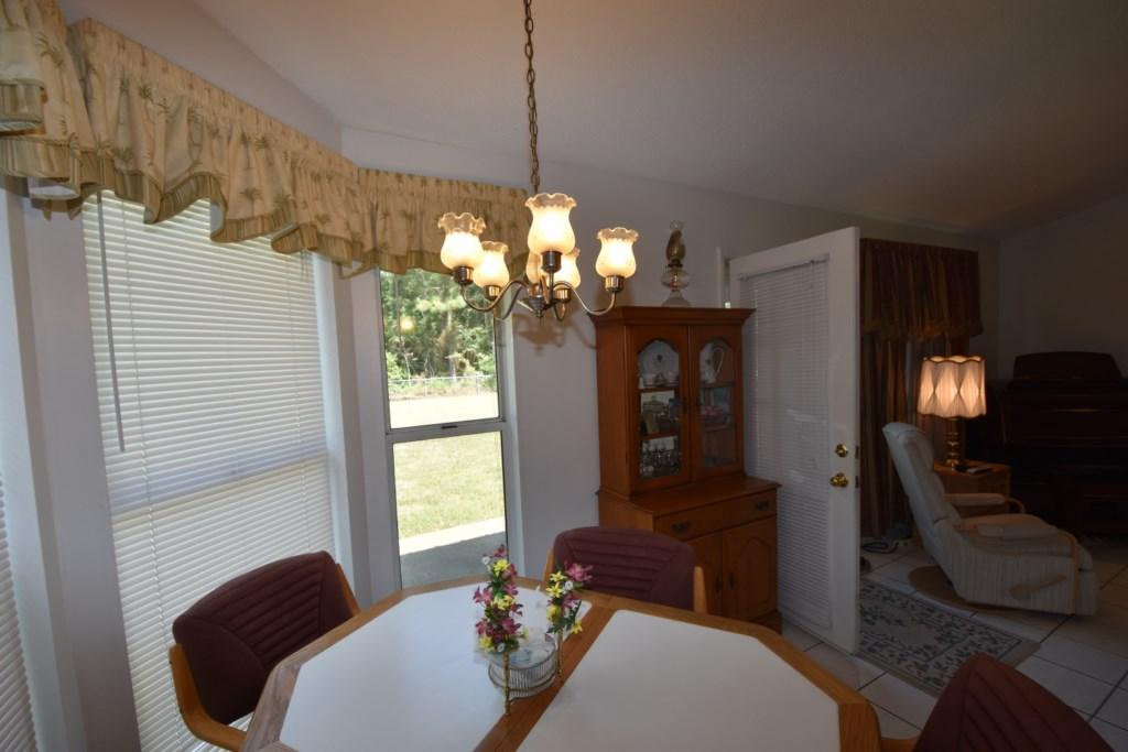 2840 Old Mill Way Crestview, FL 32539 - Photo 13 of 35 a living room with furniture and a chandelier