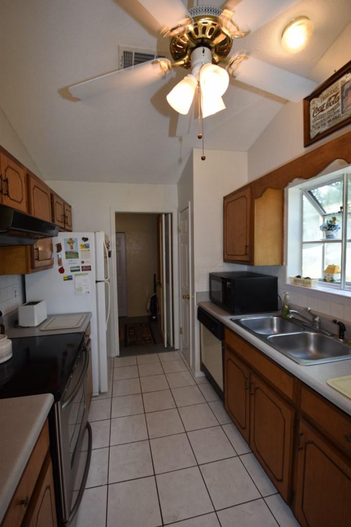 2840 Old Mill Way Crestview, FL 32539 - Photo 15 of 35 a kitchen with stainless steel appliances a sink stove and refrigerator