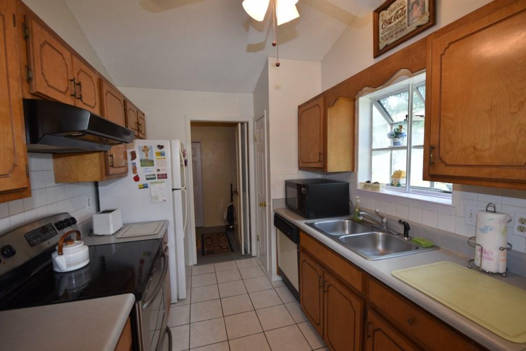 2840 Old Mill Way Crestview, FL 32539 - Photo 16 of 35 a kitchen with stainless steel appliances a sink stove and a refrigerator