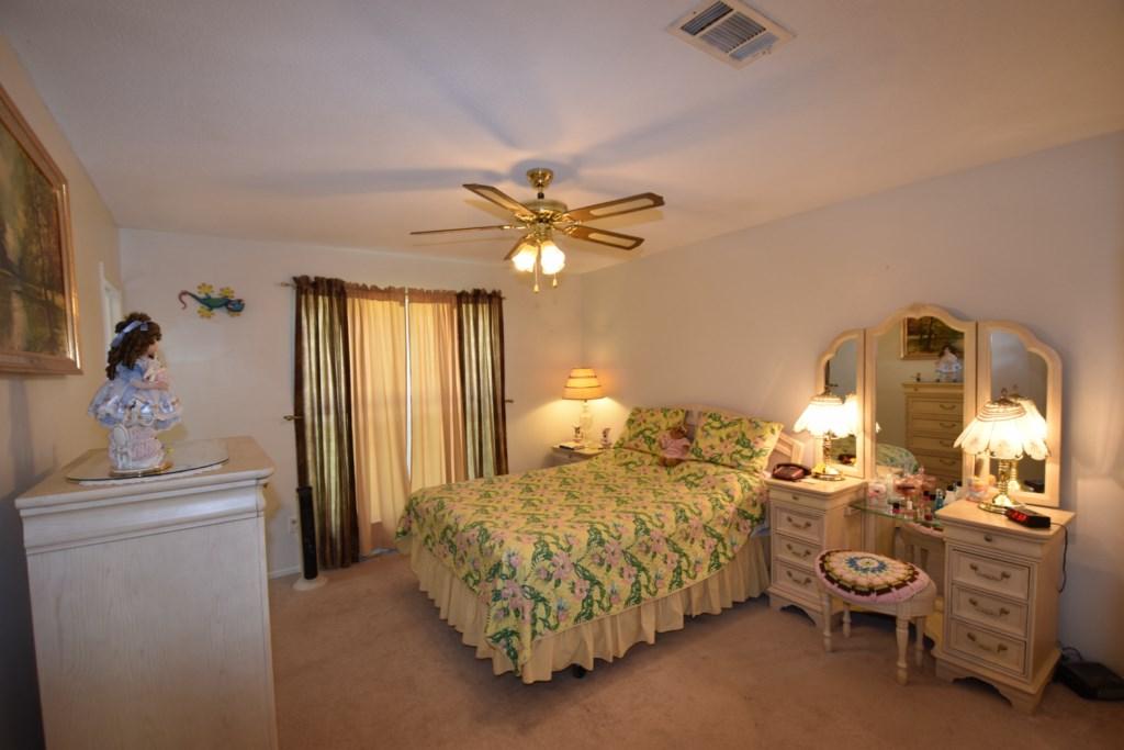 2840 Old Mill Way Crestview, FL 32539 - Photo 26 of 35 a bedroom with a bed and a chandelier