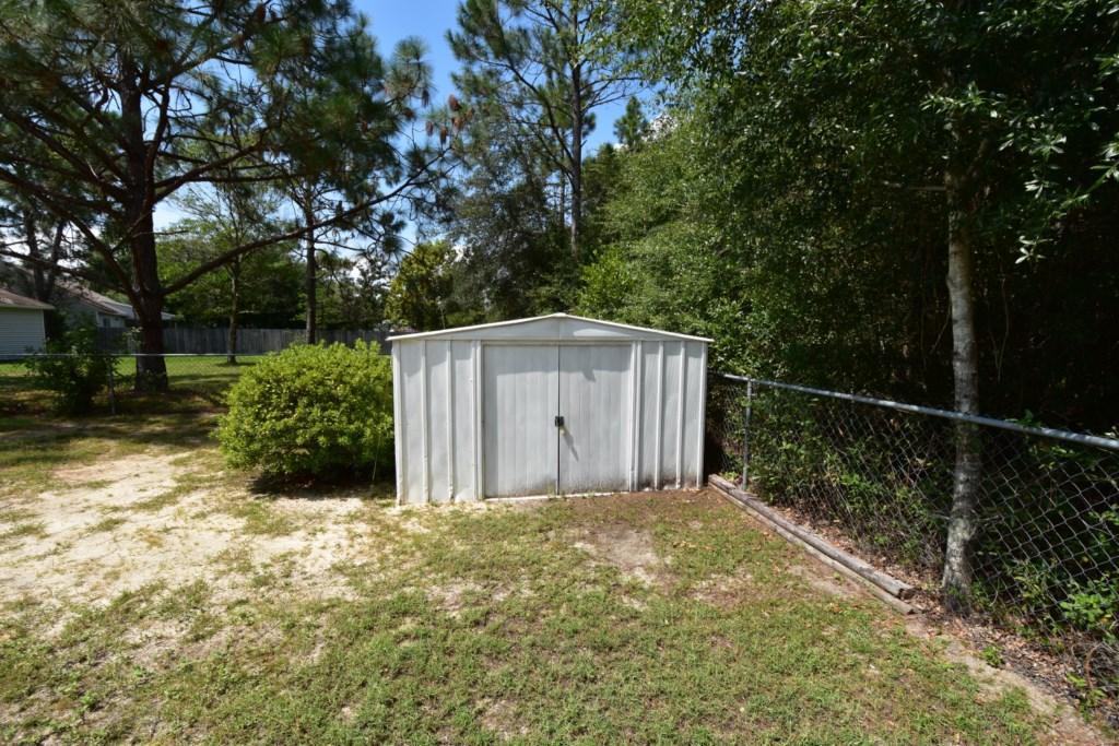 2840 Old Mill Way Crestview, FL 32539 - Photo 31 of 35 a backyard of a house with lots of green space