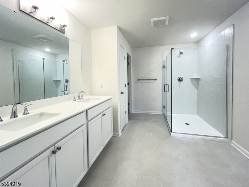 223 Myrtle Road Warren, NJ 07059 - Photo 8 of 17 a bathroom with a double vanity sink mirror and shower