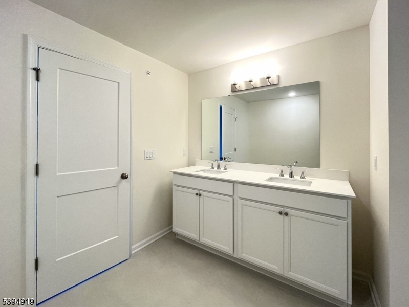 223 Myrtle Road Warren, NJ 07059 - Photo 9 of 17 a bathroom with a double vanity sink and mirror