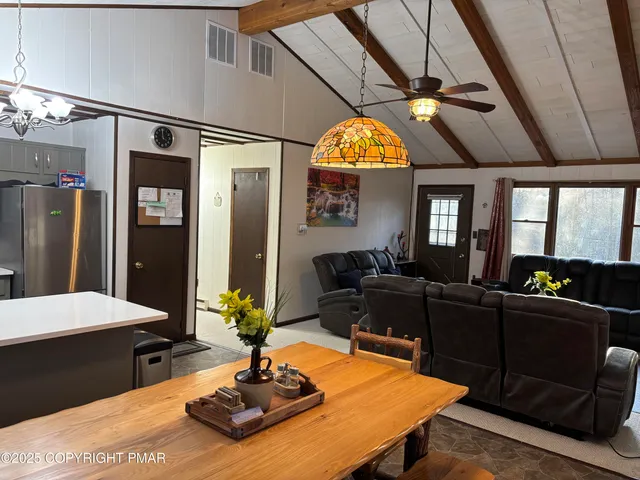 a living room with fireplace furniture and a chandelier