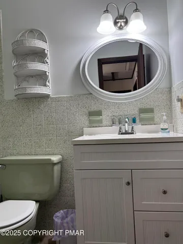 a bathroom with a toilet and a mirror