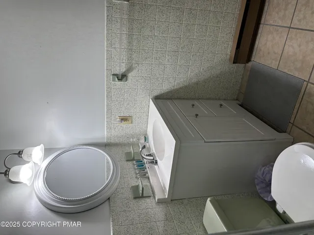 a bedroom with a bed and painting on the wall