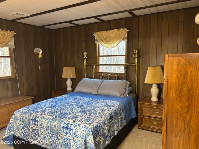 a bedroom with a bed and a dresser in it