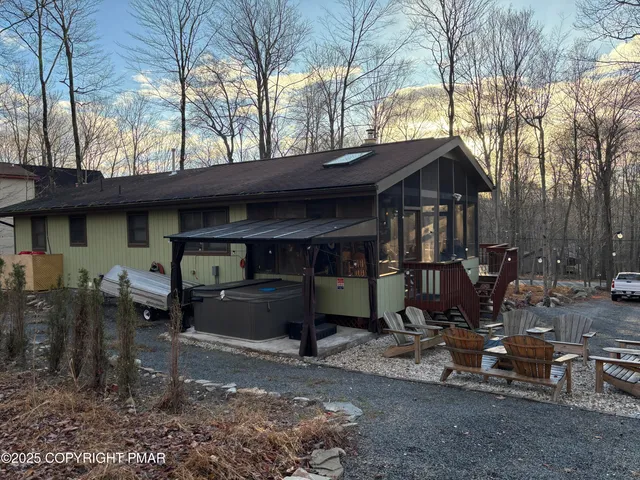 a view of a chairs and table in the backyard