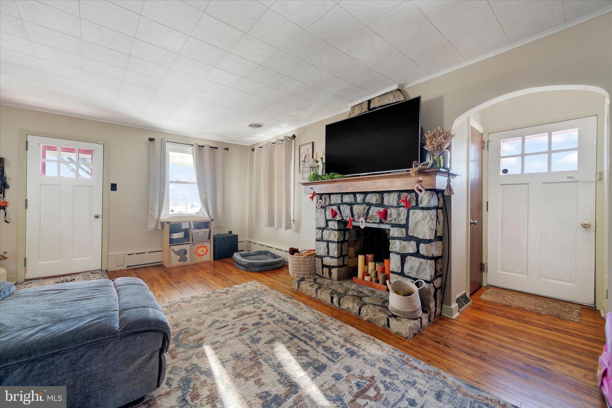 570 Oysterdale Road Oley, PA 19547 - Photo 2 of 26 a living room with furniture and a flat screen tv