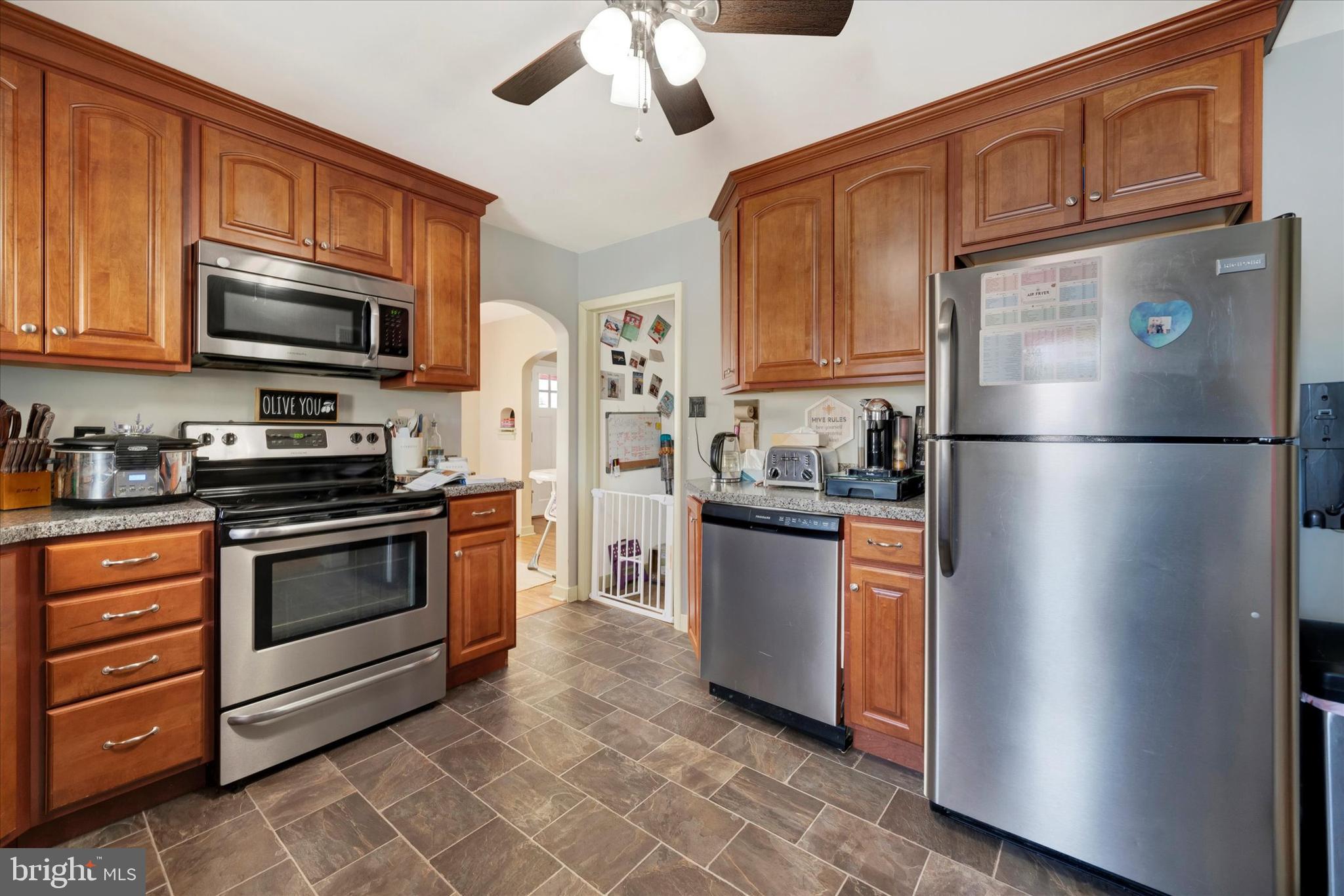 570 Oysterdale Road Oley, PA 19547 - Photo 8 of 26 a kitchen with stainless steel appliances granite countertop a refrigerator stove top oven a sink and dishwasher