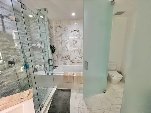 a bathroom with a shower and a toilet