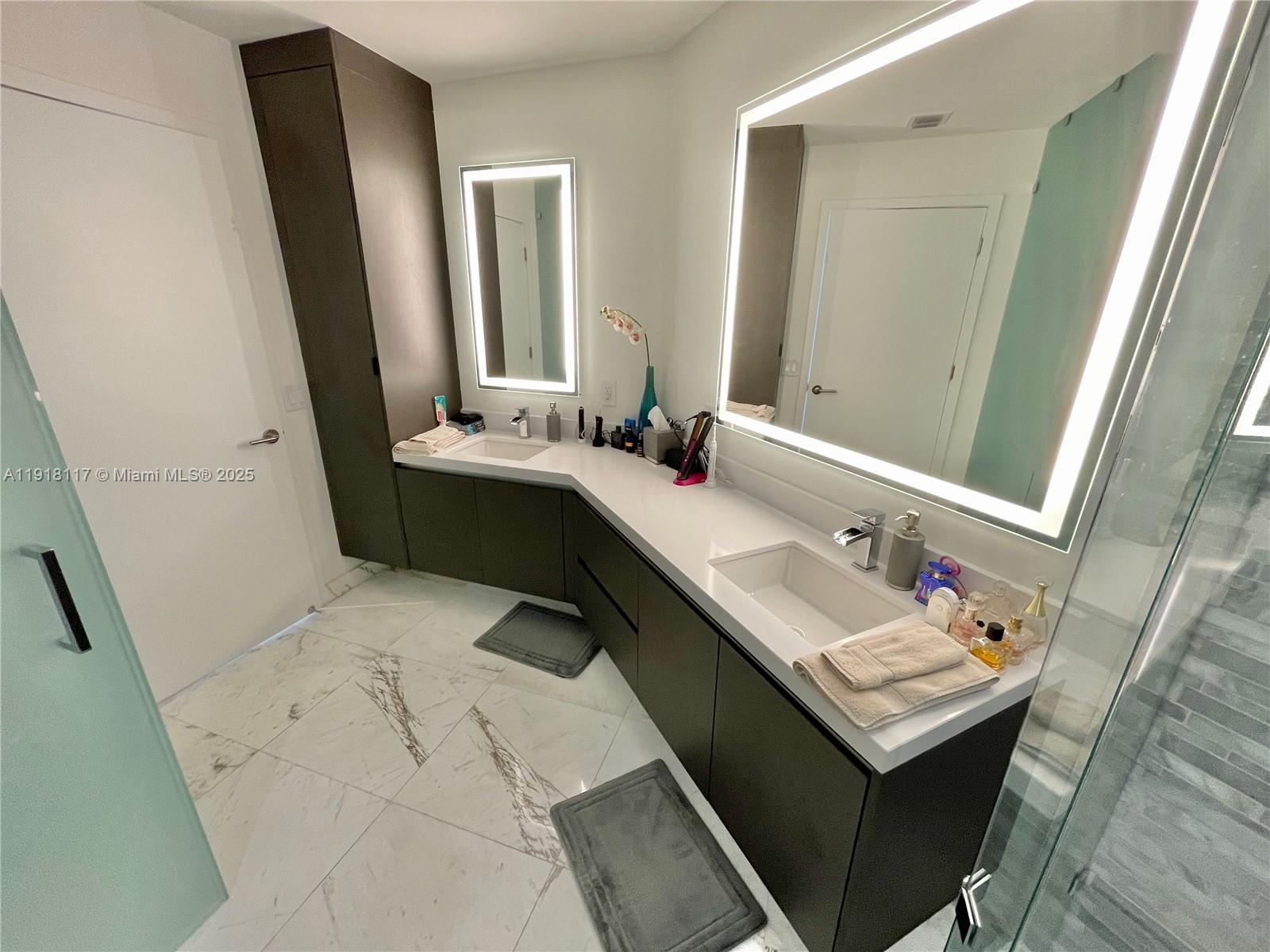 851 Northeast 1st Avenue, Unit 2605 Miami, FL 33132 - Photo 13 of 49 a bathroom with a sink and a mirror