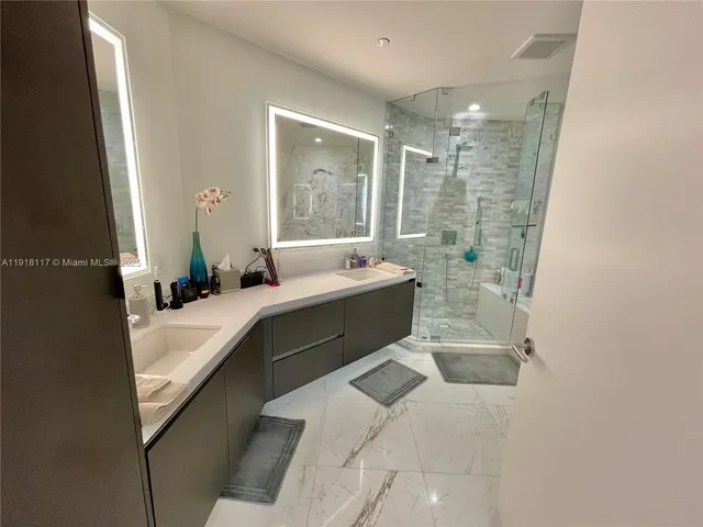 a bathroom with a tub sink and mirror