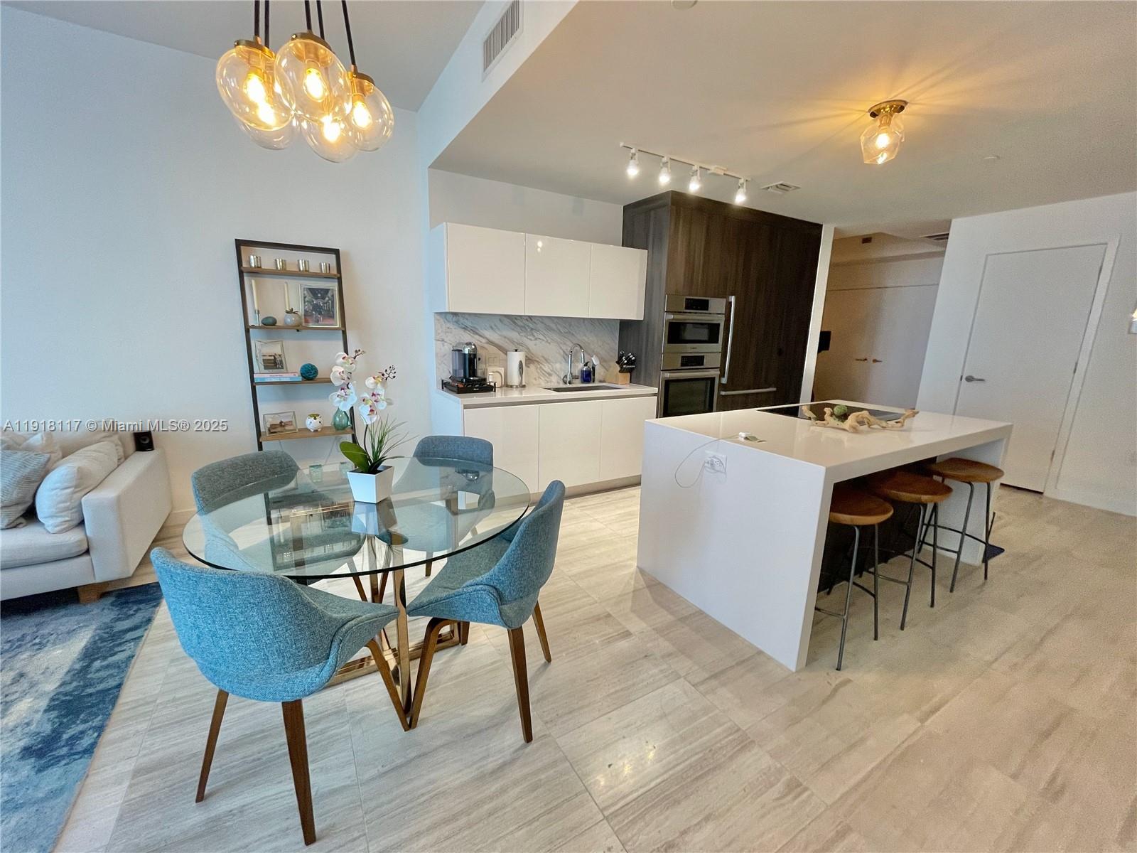 851 Northeast 1st Avenue, Unit 2605 Miami, FL 33132 - Photo 2 of 49 a view of a dining room with furniture and wooden floor