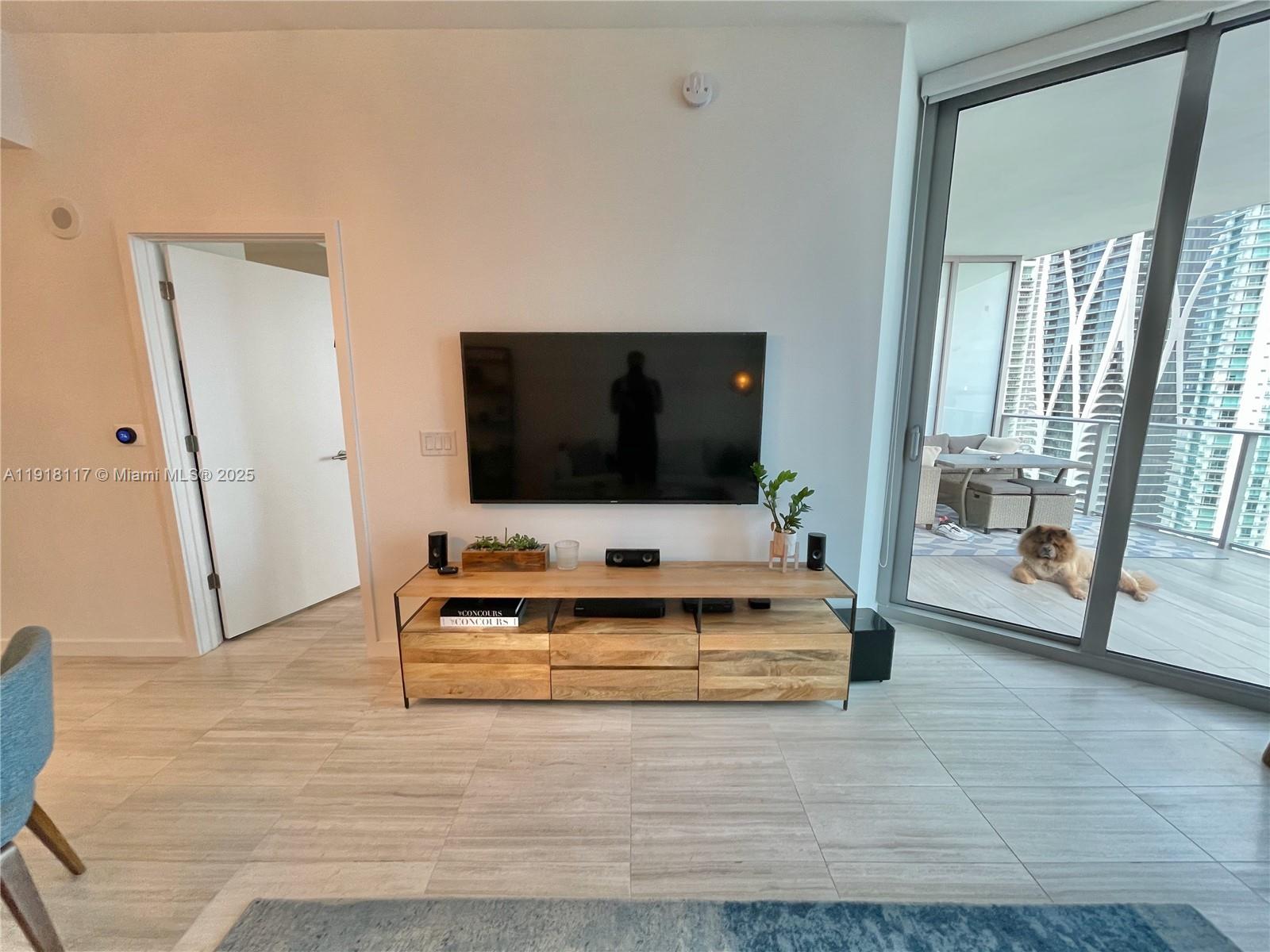 851 Northeast 1st Avenue, Unit 2605 Miami, FL 33132 - Photo 21 of 49 a living room with furniture and a flat screen tv