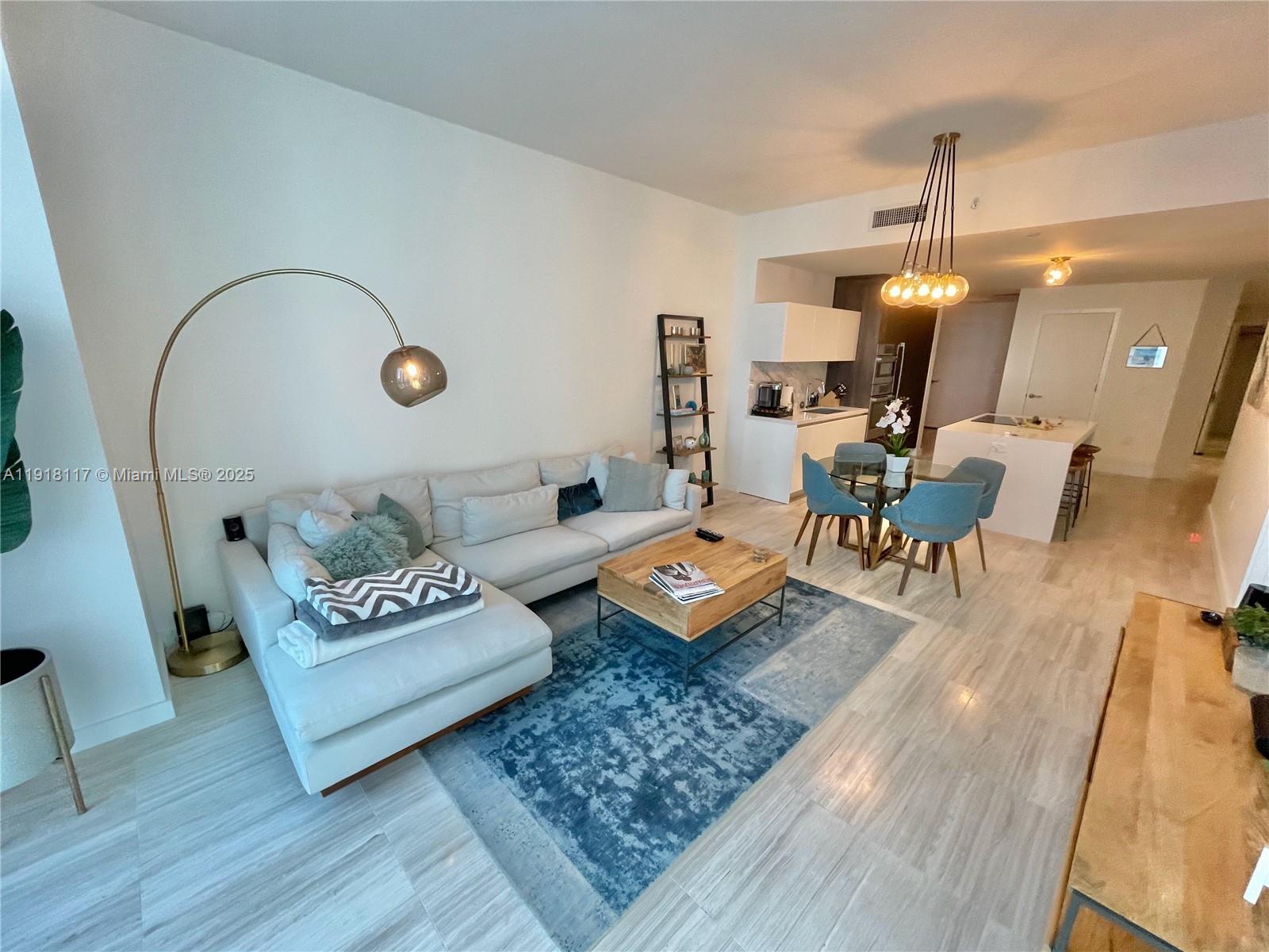 851 Northeast 1st Avenue, Unit 2605 Miami, FL 33132 - Photo 25 of 49 a living room with furniture and wooden floor