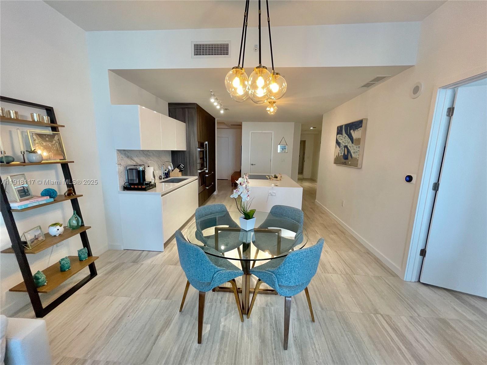 851 Northeast 1st Avenue, Unit 2605 Miami, FL 33132 - Photo 27 of 49 a view of a dining room with furniture and wooden floor