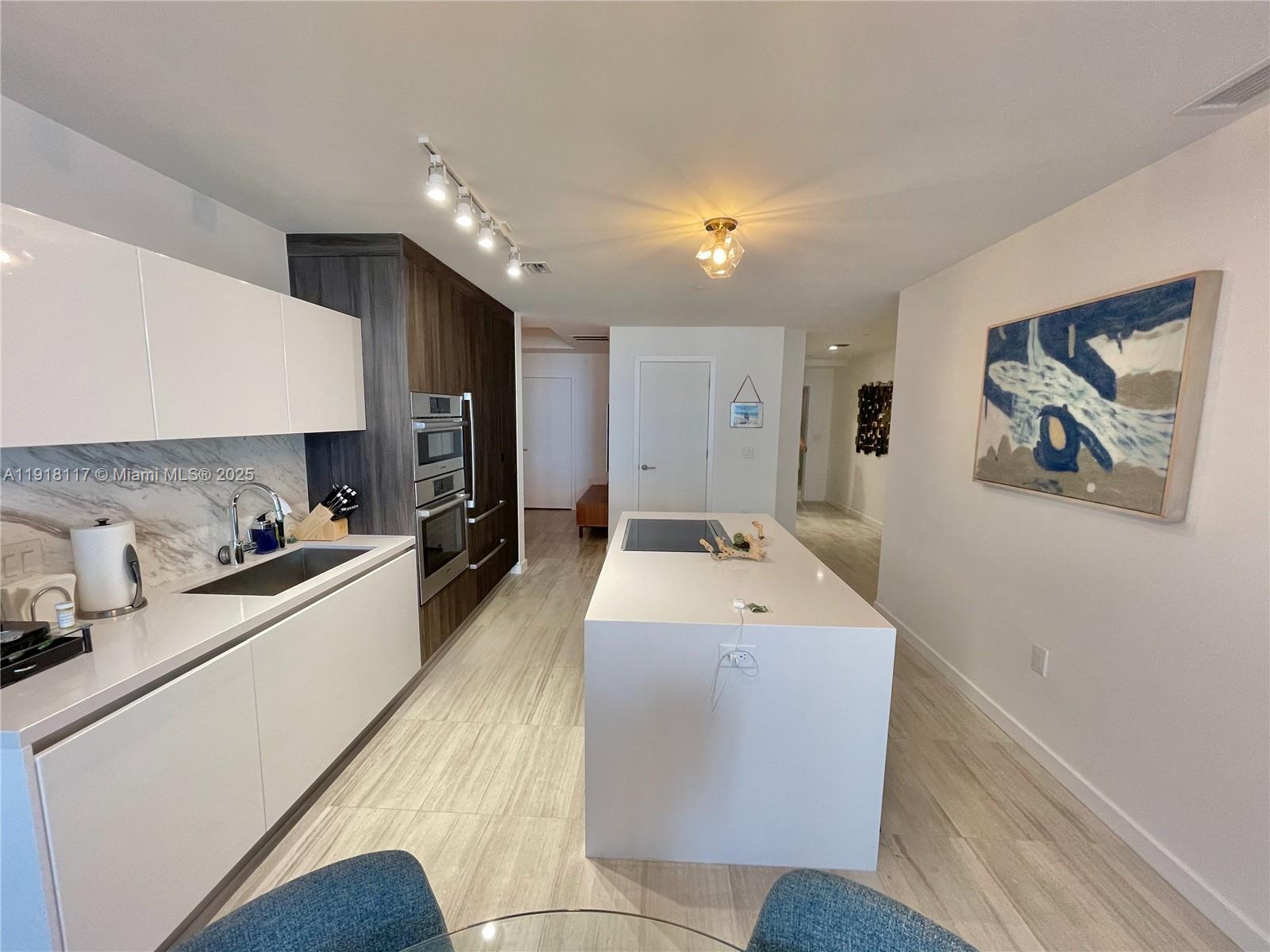 851 Northeast 1st Avenue, Unit 2605 Miami, FL 33132 - Photo 28 of 49 a large white room with a large window