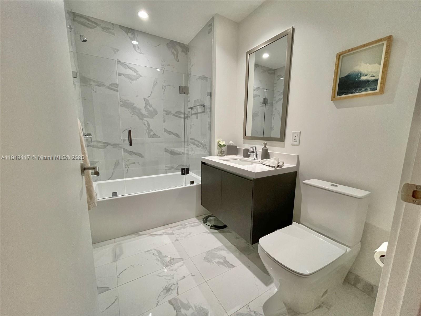 851 Northeast 1st Avenue, Unit 2605 Miami, FL 33132 - Photo 37 of 49 a bathroom with a sink toilet and shower