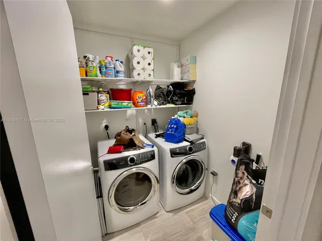 a view of a hallway with wooden floor and a potted plant